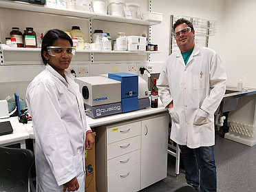 Ruchira Ranaweera and David Jeffery in their lab with a HORIBA Aqualog.