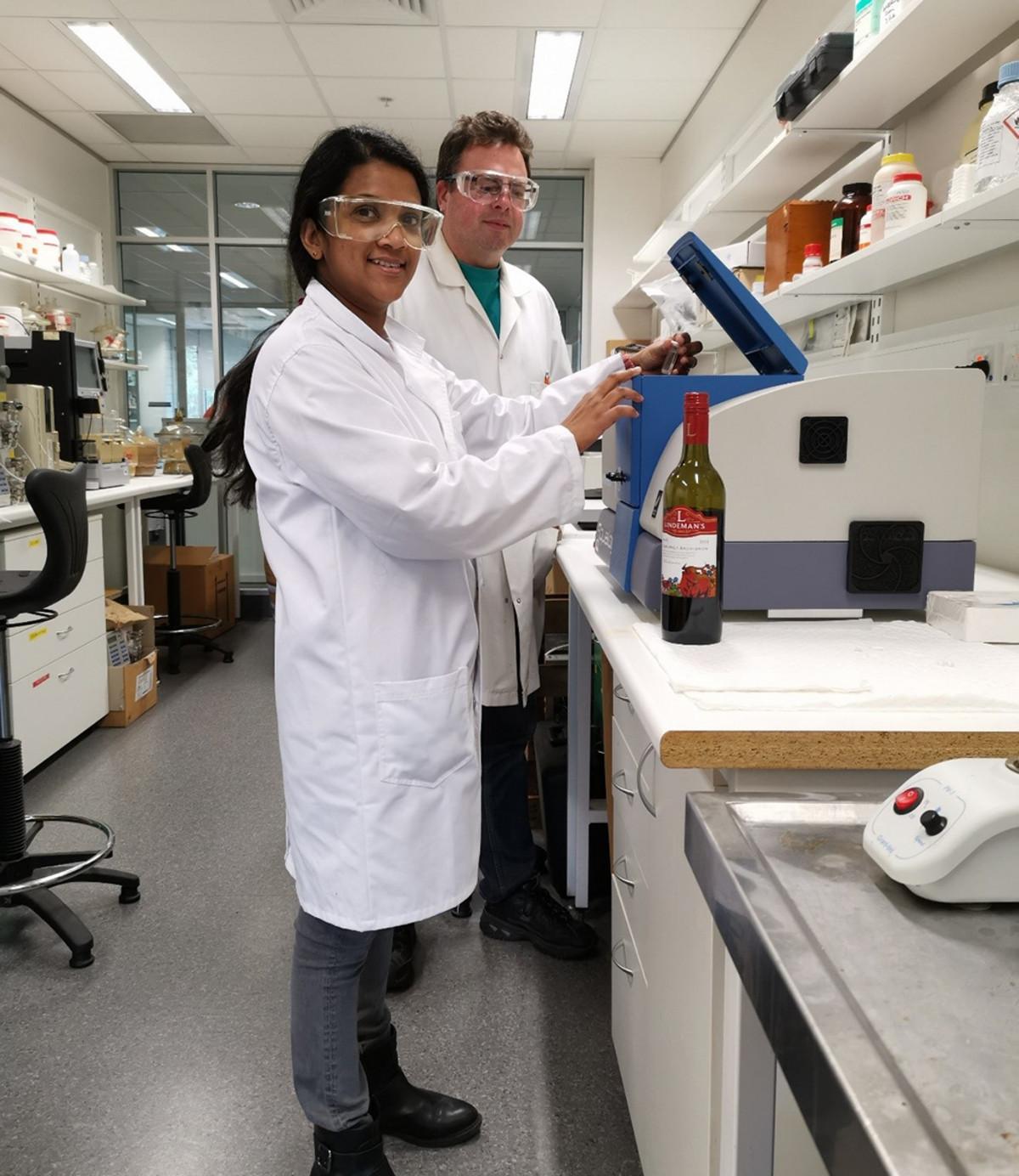 Ruchira Ranaweera loading a wine sample in the Aqualog with David Jeffery. 