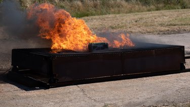 Battery pack undergoing thermal runaway emissions testing to measure safety and performance during extreme conditions